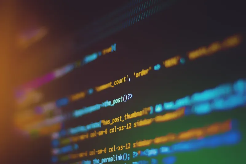 Hands typing on a keyboard with terminal code on screen